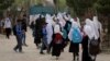 FILE - Afghan students leave school classes in a primary school in Kabul, Afghanistan on March 27, 2021. 