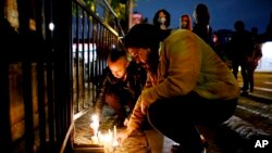 Fans of the US band Foo Fighters place lights in front of the hotel where the band's drummer Taylor Hawkins was found dead in Bogota, Colombia, March 26, 2022.
