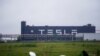 FILE - Tesla signage is seen at its factory in Shanghai, China, May 13, 2021.