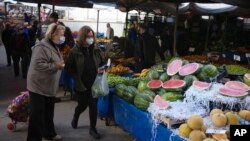 FILE - People buy local products at an open air market, in Ankara, Turkey, May 8, 2022. Inflation in Turkey soared to nearly 70% in April, official data showed, as skyrocketing prices eat away at earnings and put even basic necessities out of reach for many households.