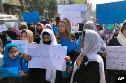FILE - Afghan women protest their lack of rights in Kabul, Afghanistan, March 26, 2022.