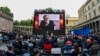 FILE - Spectators attend the award ceremony at the 71st Berlinale Summer Festival at the open-air cinema Museum Island. A photo of Mohammad Rasoulof of Iran, a member of the 2021 International Jury, can be seen on the big screen in Berlin, Germany, June 1