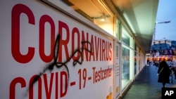 A woman walk next to an abandoned COVID-19 testing center in Frankfurt, Germany, Nov. 2, 2021