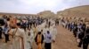 FILE - Priests celebrate a mass at the site where Jesus is believed by Christians to have been baptized by John the Baptist, in the Jordan River valley, some 50kms (30 miles) southwest of the Jordanian capital Amman, Jan. 14, 2022. 