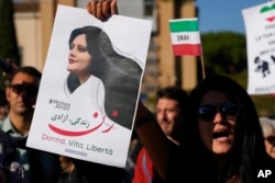 FILE - People protest the death of Mahsa Amini, a woman who died in police custody in Iran, during a rally in central Rome, Oct. 29, 2022.