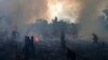FILE - Fire brigade members work to put out fires in Apui, Amazonas state, Brazil, Sept. 21, 2022. Deforestation in the Brazilian Amazon slowed slightly last year, a year after a 15-year high, according to closely watched numbers published Nov. 30.