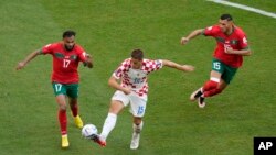 From left, Morocco's Sofiane Boufal, Croatia's Mario Pasalic, and Morocco's Selim Amallah vie for the ball during the World Cup group F soccer match between Morocco and Croatia at the Al Bayt Stadium in Al Khor, Qatar, Nov. 23, 2022.