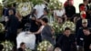 Pele's daughter, Kelly Cristina Nascimento, is seen next to the body of Brazilian soccer legend Pele in his casket, as he lays in state on the pitch of his former club Santos' Vila Belmiro Stadium in Santos, Jan. 2, 2023.
