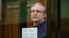 FILE - Paul Whelan, a former U.S. Marine who was arrested for alleged spying, listens to the verdict in a courtroom at the Moscow City Court in Moscow, June 15, 2020. 