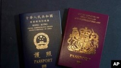 FILE - This Jan. 29, 2021, file photo features a British National (Overseas) passport and a Hong Kong Special Administrative Region of the People's Republic of China passport. 