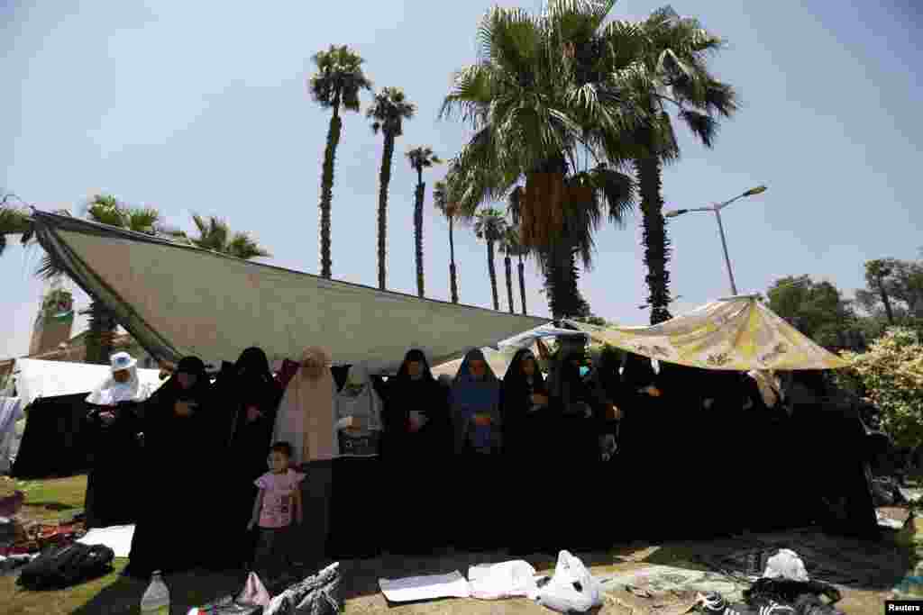 Protesters, who support former Egyptian President Mohamed Morsi, perform Friday prayers near Cairo University in Cairo, July 5, 2013.&nbsp;