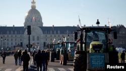 French farmers gather with their tractors near the Invalides during a protest over pesticide restrictions and other environmental regulations, in Paris, Feb. 8, 2023.