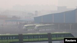 FILE - People commute in a Mumbai Monorail on a smoggy morning in Mumbai, India, Jan. 7, 2021.