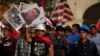 Bearing signs with the photos of the victims of the ongoing political violence, demonstrators march against Peruvian President Dina Boluarte in Lima, Peru, Feb. 1, 2023.