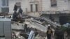 People gather as rescuers search for survivors under the rubble, following an earthquake, in rebel-held town of Jandaris, Syria Feb. 6, 2023.