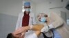 FILE - Ukrainian doctor Oleh Duda, centre, examines a patient at the hospital in western city of Lviv, Ukraine, Nov. 26, 2022. 