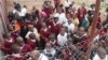 Students, visibly excited, are seen gathered at their school's opening, at Michiru View School in Blantyre, Malawi. (Lameck Masina/VOA)