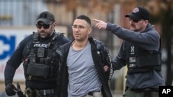 Solomon Pena, a Republican candidate for New Mexico House District 14, is taken into custody by Albuquerque Police officers, Jan. 16, 2023, in southwest Albuquerque, N.M. 