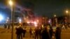 People look at a fire outside a hotel providing refuge to asylum seekers following a protest in Knowsley near Liverpool, Britain February 10, 2023 in this still image obtained from a social media video. 