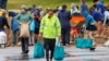 People fill sandbags at a public collection point in preparation for the arrival of a sub-tropical low-pressure system known as Gabrielle in Auckland, New Zealand, Feb. 12, 2023.