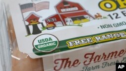 FILE - In this Monday, July 9, 2018 photo a "USDA Organic" label is printed on the label of a carton of a dozen eggs, in Walpole, Mass. 