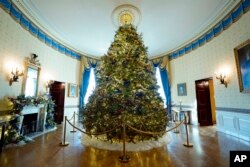 The White House Christmas Tree is on display in the Blue Room of the White House during a press preview of holiday decorations at the White House, Nov. 28, 2022, in Washington.