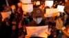Protesters hold up blank papers and chant slogans as they march in Beijing, Nov. 27, 2022. 