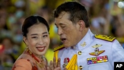 FILE - Thai King Maha Vajiralongkorn speaks with Princess Bajrakitiyabha while meeting supporters in Bangkok, Thailand, Nov. 1, 2020. 
