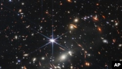 This image provided by NASA on July 11, 2022, shows galaxy cluster SMACS 0723, captured by the James Webb Space Telescope. The telescope is designed to peer back so far that scientists can get a glimpse of the dawn of the universe about 13.7 billion years ago.