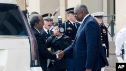 U.S. Defense Secretary Lloyd Austin greets Somali President Hassan Sheik Mohamud, left, during a welcome ceremony at the Pentagon, near Washington, Sept. 15, 2022.