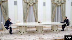 French President Emmanuel Macron (R) meets with Russian President Vladimir Putin (L) in Moscow on Feb. 7, 2022, for talks in an effort to find common ground on Ukraine and NATO.