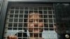 FILE - An ethnic Uighur boy inside a police van in Khlong Hoi Khong, Thailand is seen in this March 15, 2014 photo.