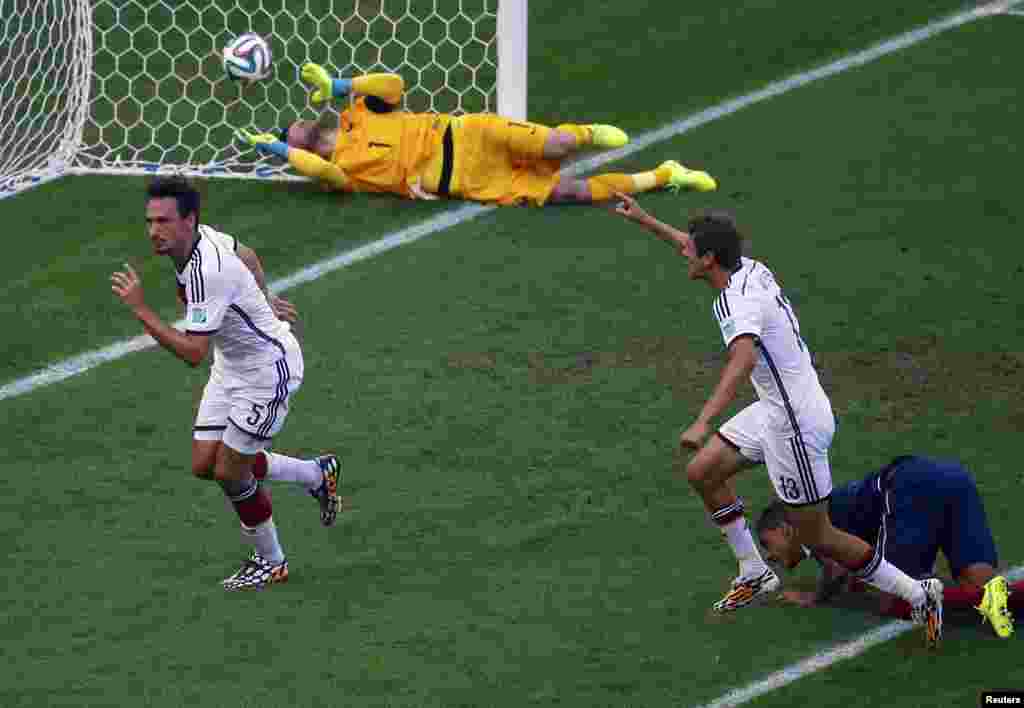 Germaniya o&#39;yinchilari Tomas Muller va Mats Hummels Fransiya darvozasiga kiritilgan golni nishonlamoqda, 4-iyul, 2014-yil.