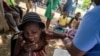 A woman injured after Saturday's 7.2 magnitude quake reacts while being treated at the Ofatma Hospital, in Les Cayes, Haiti, August 18, 2021. 