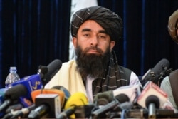 FILE - Taliban spokesperson Zabihullah Mujahid looks on as he addresses the first press conference in Kabul on Aug. 17, 2021.