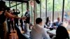 U.S. Secretary of State Antony Blinken, right, meets with U.S. Exchange Alumni at a cafe in Bangkok, July 10, 2022. 