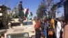 Pejuang Taliban berjaga-jaga di sepanjang pinggir jalan di Herat, kota terbesar ketiga di Afghanistan, 13 Agustus 2021. (AFP)
