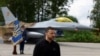 FILE P- Ukraine's President Zelenskiy speaks to the media in a front of an F-16 fighter jet at an undisclosed location in Ukraine, Aug. 4, 2024. 