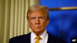 FILE - U.S. President-elect Donald Trump attends a meeting with French President Emmanuel Macron at the Elysee Palace in Paris, Dec. 7, 2024. 