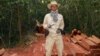 In this photo taken Feburary 6, 2012 and released by The Cambodian Center for Human Rights (CCHR), Chut Wutty stands on wooden planks of log in a jungle in Kampong Thom province in northern of Phnom Penh, Cambodia.