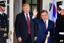 FILE - South Korean President Moon Jae-in waves as he is welcomed by U.S. President Donald Trump to the White House in Washington, May 22, 2018.