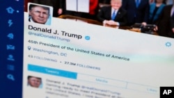 FILE - A photo of then-President Donald Trump's Twitter feed on a computer screen in Washington. 