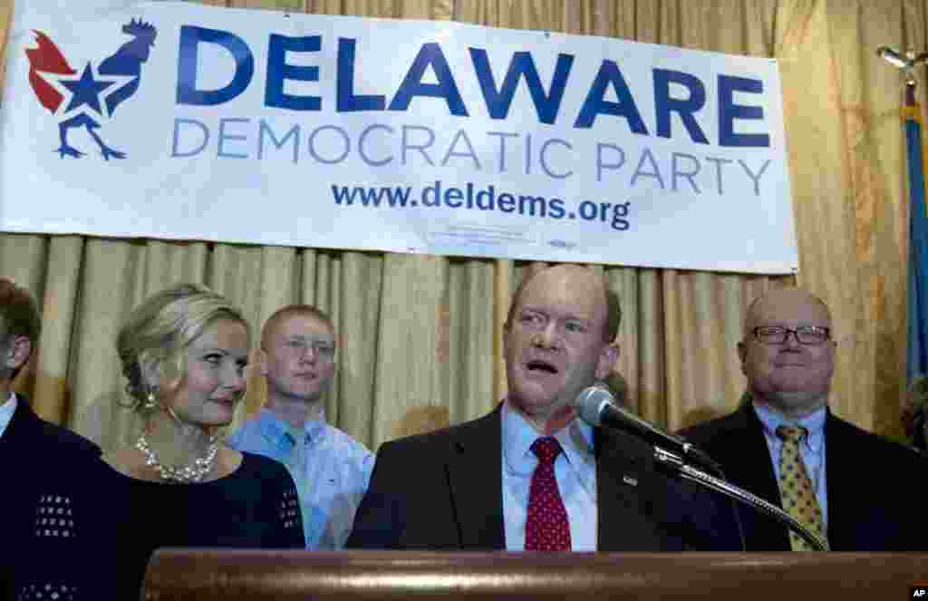 Sen. Chris Coons D-Del., accompanied by his wife Annie (left) and family, speaks to supporters during an election night party in Newark, Delaware, after winning his re-election bid for the Senate, Nov. 4, 2014.