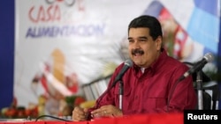 FILE - Venezuela's President Nicolas Maduro speaks during an event with supporters in Caracas, Nov. 15, 2017.