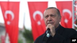 Turkish President Recep Tayyip Erdogan, delivers a speech at supporters in Istanbul, Sunday, Oct. 21, 2018. 