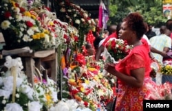 A woman buys flowers at a market on Valentine's Day in Harare, Zimbabwe, Feb. 14, 2017.