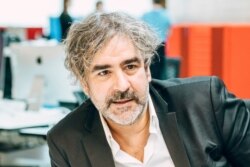 FILE - A handout picture released by German newspaper Die Welt shows German-Turkish journalist Deniz Yucel at the newspaper's headquarters in Berlin, July 16, 2020.