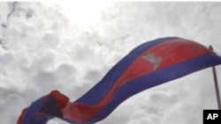 Cambodian flags flutter near a bridge where an accident took place last year during a ground breaking ceremony in Phnom Penh, Cambodia,Thursday, Aug. 11, 2011. At least 353 people were killed and 395 injured when thousands of festival-goers crammed onto a