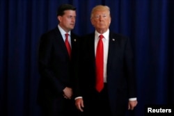 FILE - White House Staff Secretary Rob Porter (L) reminds U.S. President Donald Trump he had a bill to sign after he departed quickly following remarks at his golf estate in Bedminster, New Jersey U.S., Aug.12, 2017.
