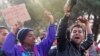 FILE - Migrants from Bangladesh shout 'Open the border!' as they protest while waiting to cross the border from Greece into Macedonia, near Gevgelija, Macedonia, Nov. 26, 2015. 